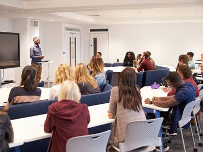 University students study in a classroom with male lecturer